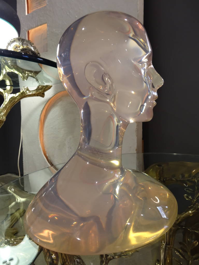 A most unusual bust of solid Lucite.
This piece is most interesting as it appears that there is a puddle of water which the head seems to be resting above.
The design of this piece and use of material gives it an exotic appearance.
Beautifully