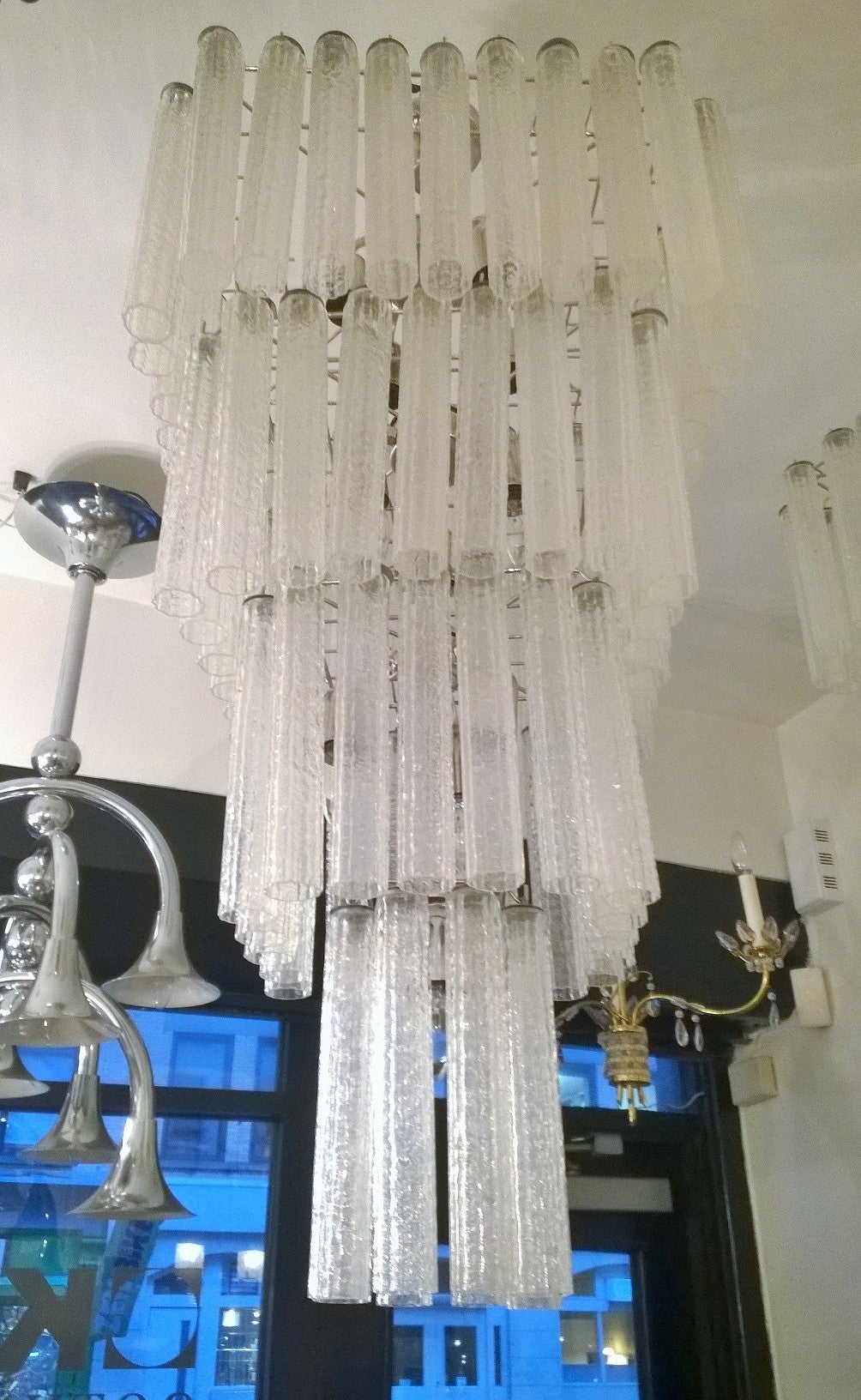 A wonderful pair of 1970s Italian Murano glass flush or pendant chandeliers. Composed of a chrome frame and numerous handblown glass tubes. We can have it flush to the ceiling or hanging by a pole or chain. Rewired.