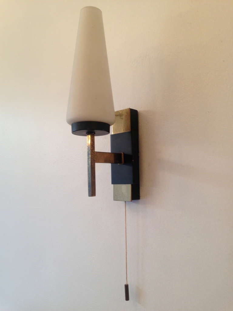 A great modern pair of 1950s French black enamel and polished brass wall lights with white opaline cone glass shades . The have brass weighted pulls but can be removed if needed. Rewired.