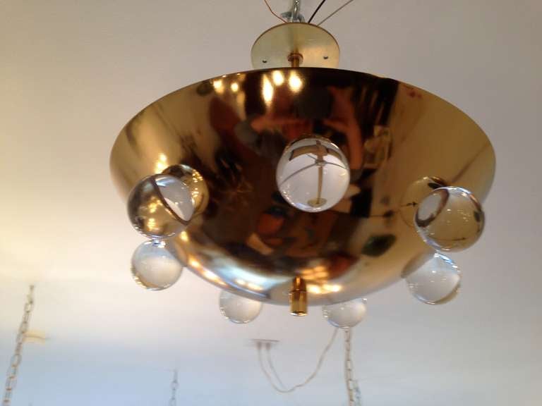 A wonderful hand crafted gold plated brass flush light with decorative solid glass crystal orbs. It has a small ceiling pole and matching solid brass canopy. The pole can be lengthened or shortened to your needs. 5 light sources . A custom and