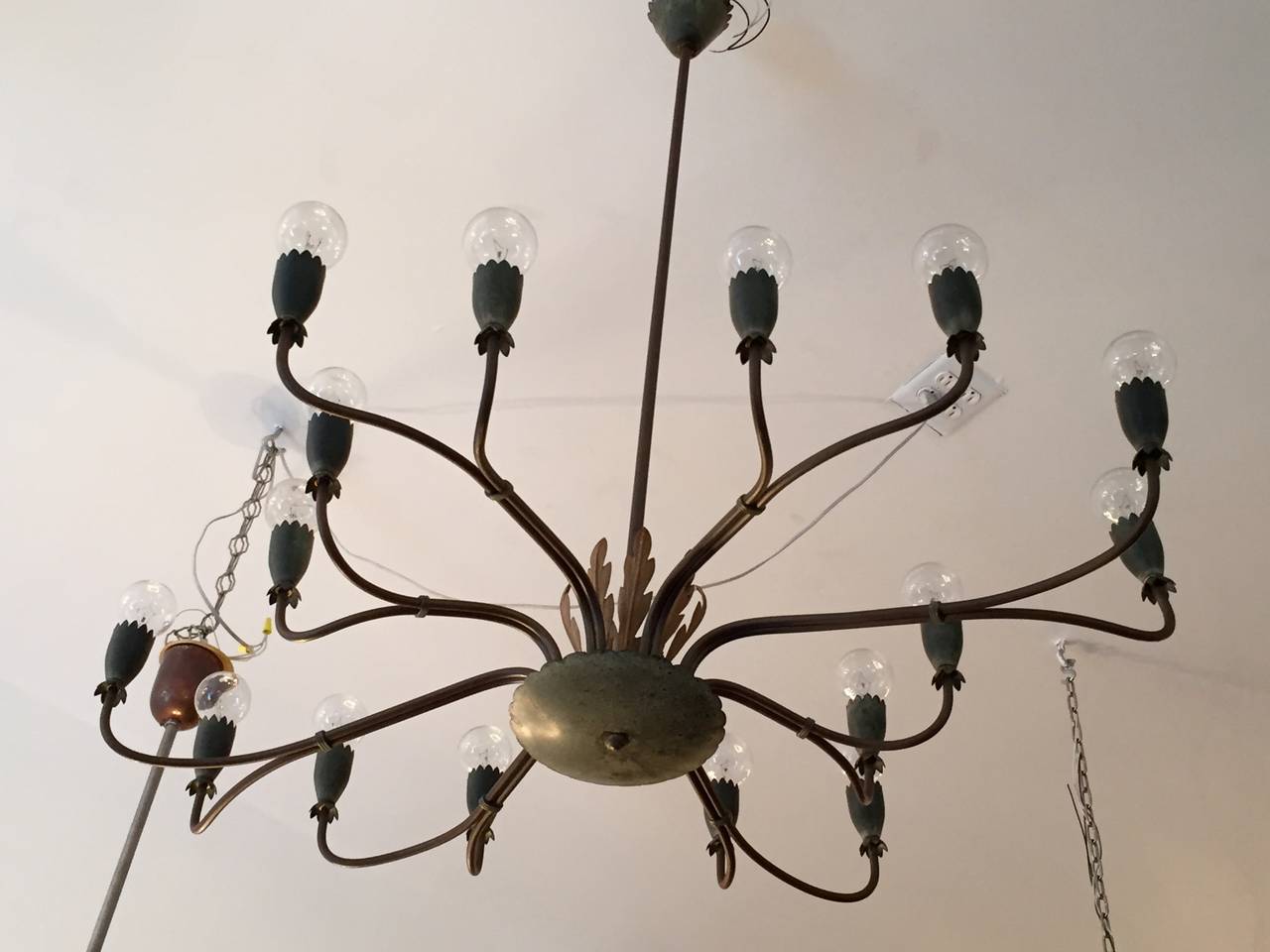 A rare 1940s Italian flowing organic sixteen-light chandelier. It is composed of aged brown copper and brass body with decorative Verdigris cups and dark cream leaves. All original. Rewired.
