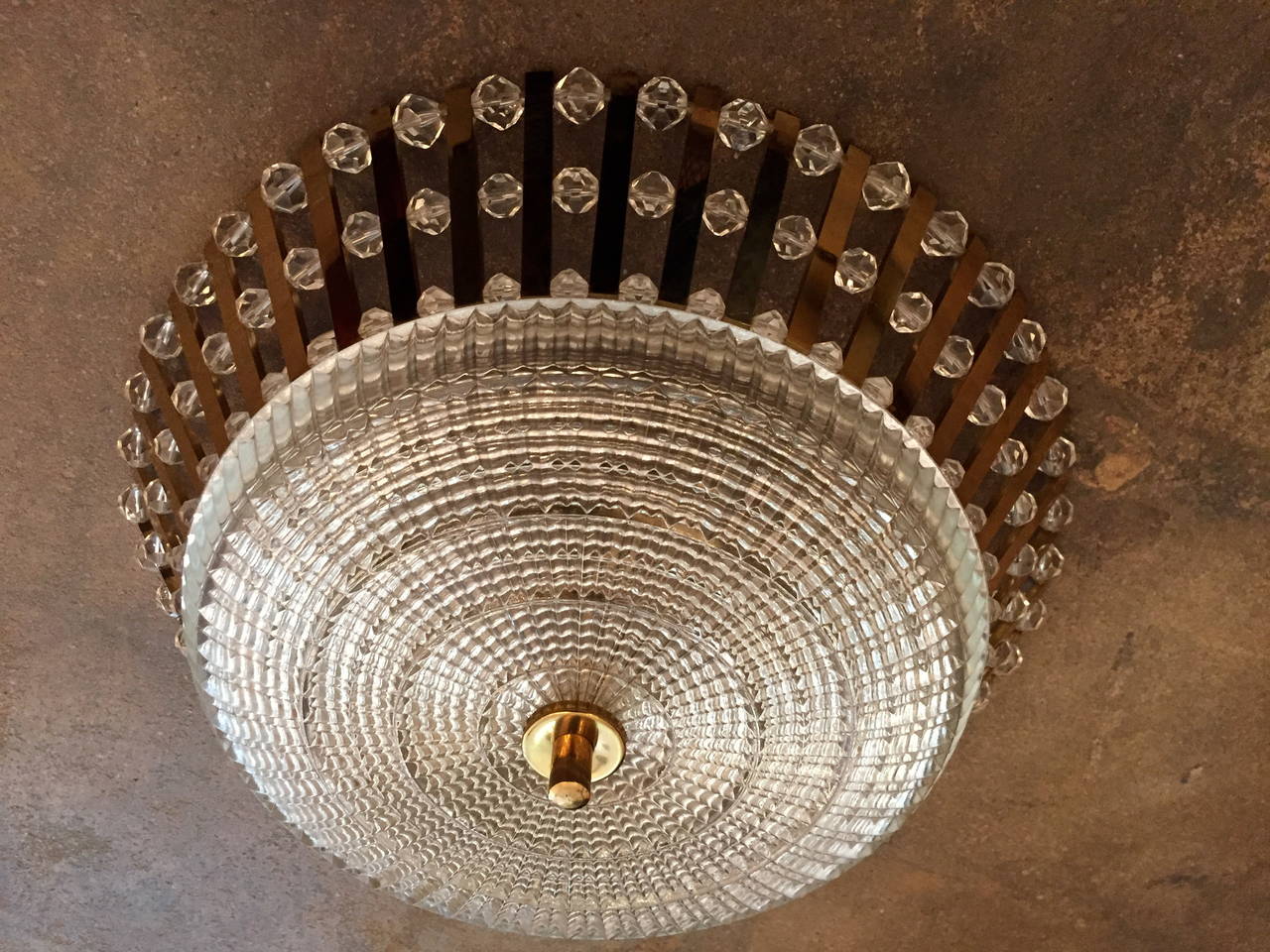 A glamorous 1950s Austrian golden polished brass ceiling light with numerous crystal beads and a cut-glass shade. Three-light sources. Rewired.