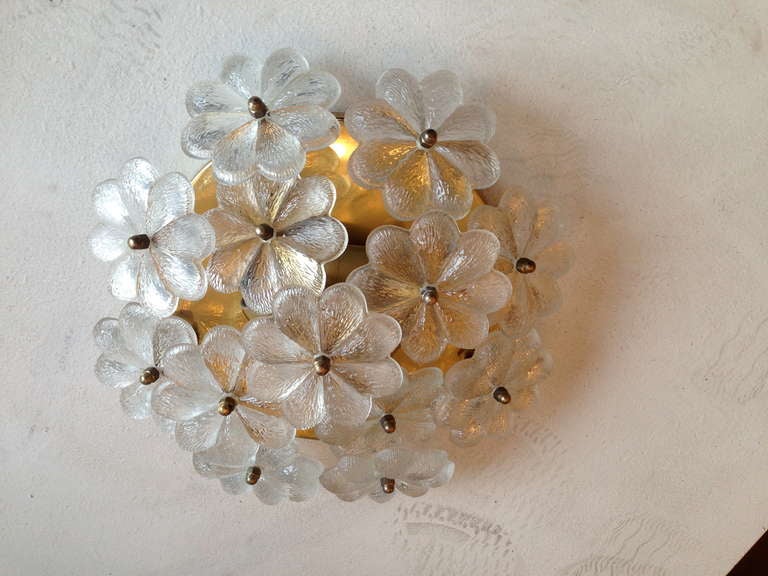 A golden 1950s Austrian polished brass ceiling light with large glass flower elements. Three light sources.