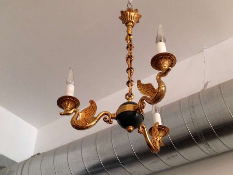 A nice French three light bronze/brass and black enamel swan chandelier from the, 1920s. Rewired.