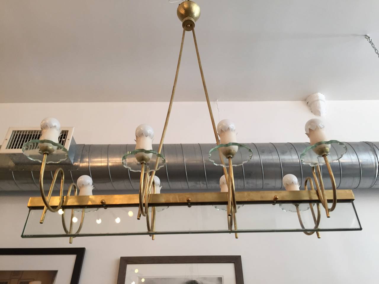 A wonderful all original 1950s Italian chandelier composed of a satin brass and white enamel fixture and fitting with one large cut crystal and eight small hand-cut crystal bobeches. Rewired.  in the stye of Fontana Arte. The height can be dropped