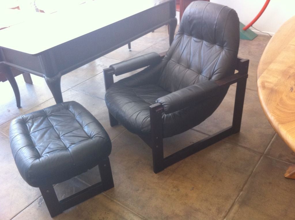 A Brazilian rosewood and leather lounge chair and ottoman by Benjamin Lafer. Original label.