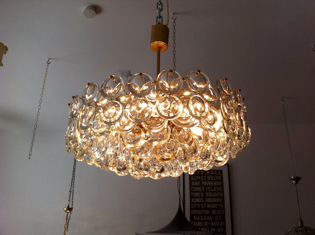 A beautiful warm Italian faceted crystal and brass chandelier by the famed lighting maker, Gaetano Sciolari. Eight light sources.