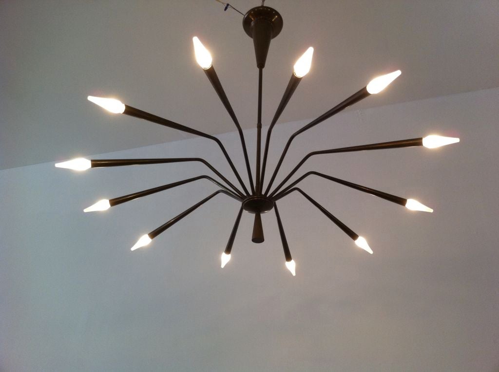 A sculptural  1950's Italian Deco Bronze Chandelier . A great  aged patina with a dark brown coloring. 12 light sources.