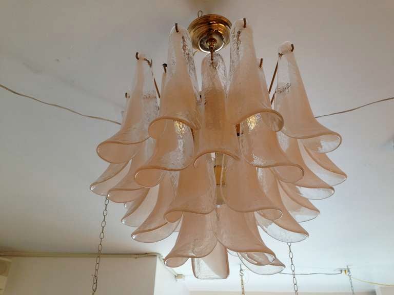 A 1970's blown Murano glass petal/ artichoke chandelier . The Italian chandelier is composed pale melon/peach/clear colored glass petals on a polished brass frame. Five light sources. Rewired. Can be flush or a pendant.