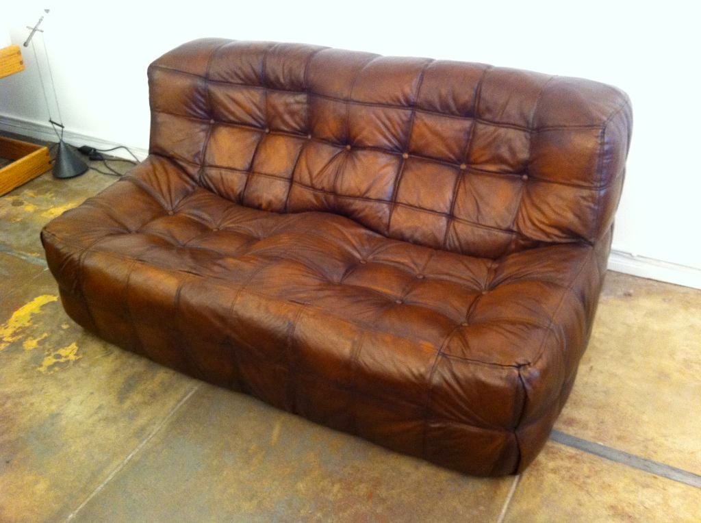 A very comfortable 1970's low brown leather French sofa by Michel Ducaroy. The leather has a great aged patina.