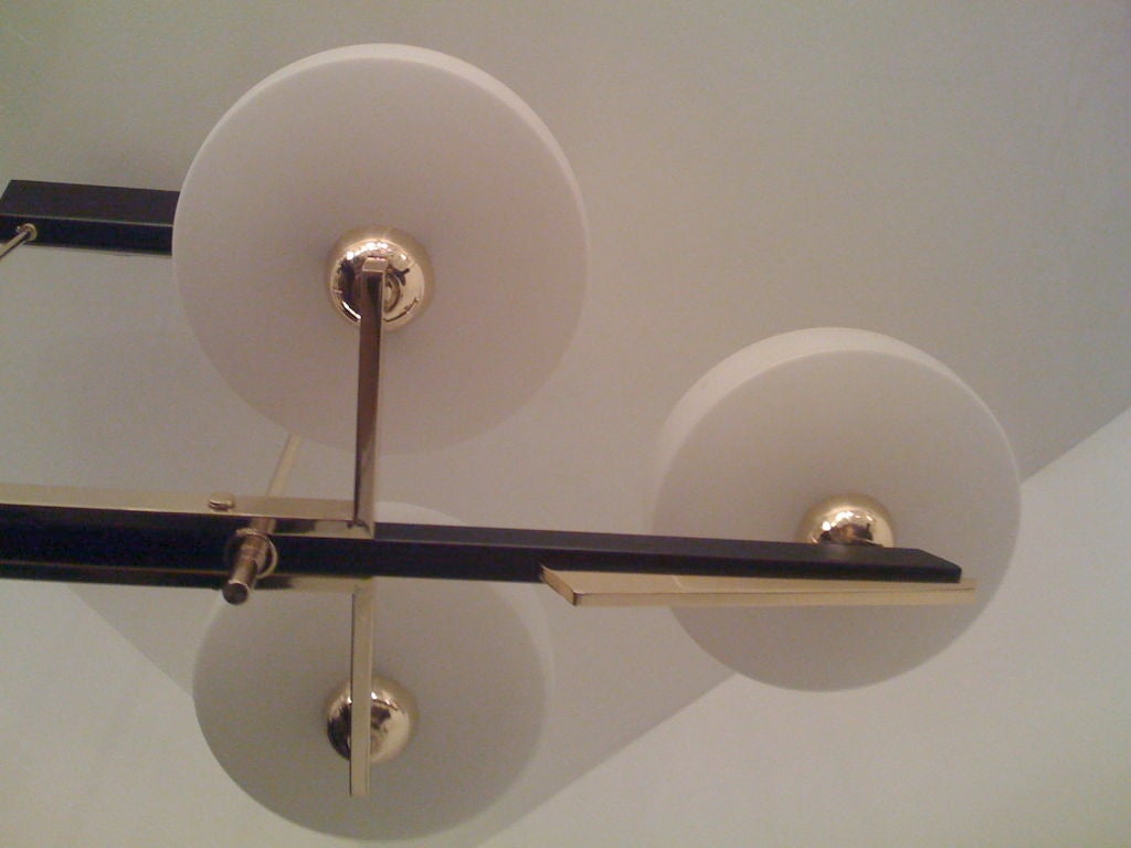 A billiard shaped 1960's French chandelier in brass,black enamel , and white frosted glass shades. Six light sources.