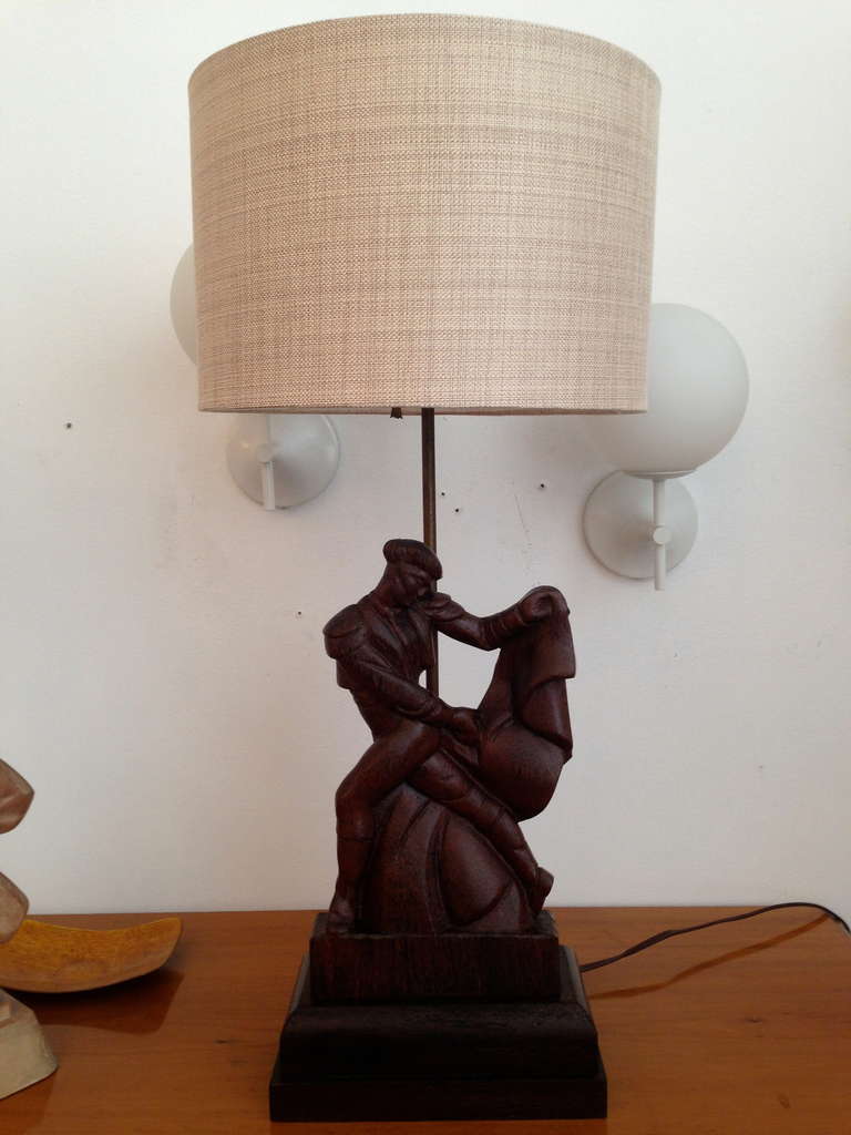 A wonderful 1940s carved wood table lamp of a young Spanish matador made by Heifetz. Rewired. Signed.