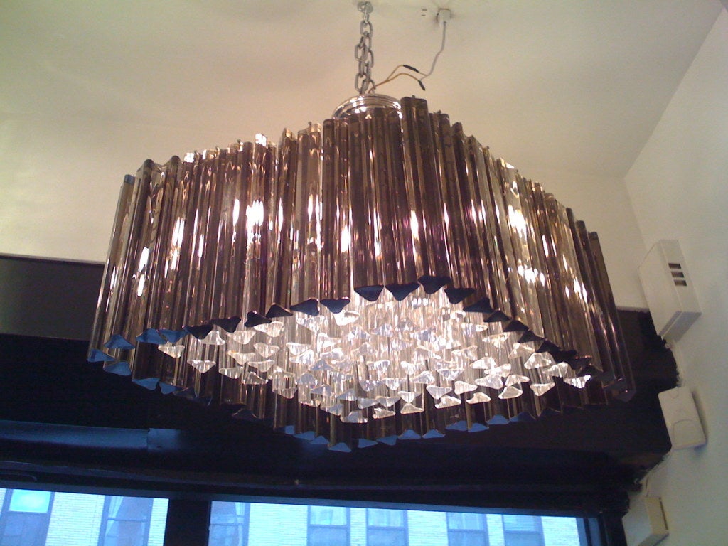 A Murano glass chandelier in a diamond shape composed of clear and smoked crystals on a chrome frame.