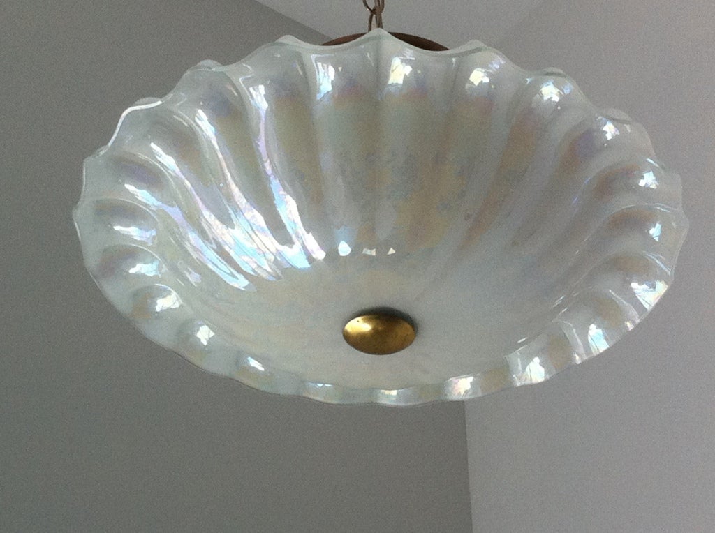 A nice Depression glass and brass flush ceiling light. The white glass has a pearl opalescent effect.