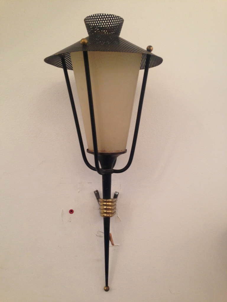 Two pairs of 1950s French sconces done in brass, black enamel and parchment shades.