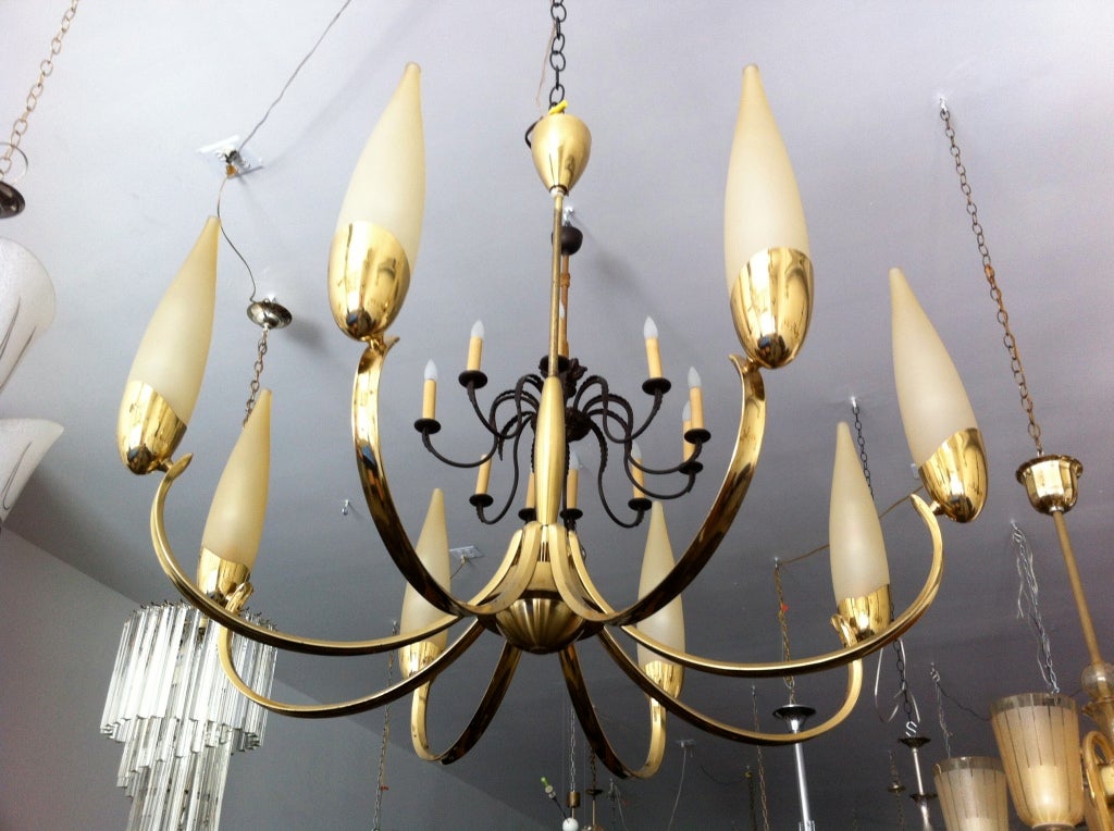 A nice 1960s Austrian polished brass swooping chandelier with gold conical glass shades. Eight light sources. Rewired. Matching wall lights available. Ceiling pole can lengthened if needed. The height of the body is 18 inches.