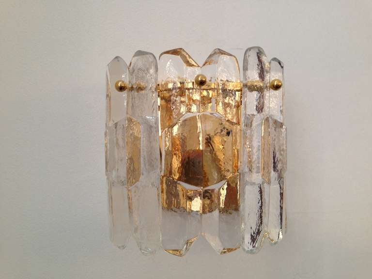 A 1960s gold-plated wall light with thick ice like glass elements. Three light sources.