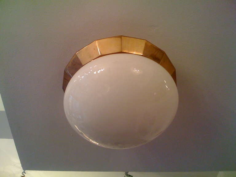 A wonderful 1920's Austrian  brass ceiling fixture with a milk glass shade. Two light sockets.