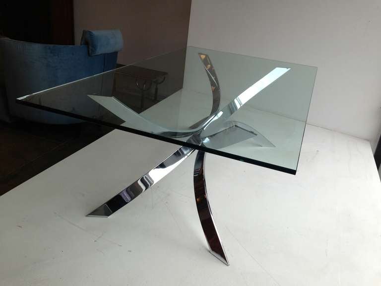 A chrome plated steel 1970's cocktail table with a half inch rectangular glass top in the style of French designer Maria Pergay. The base can accommodate a larger top. The base measures 42