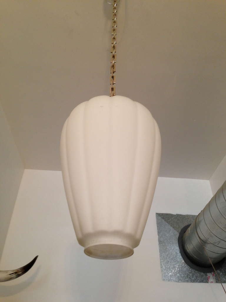An original 1930s American Art Deco pendant light with chrome chain and fittings holding large frosted glass shade. Ceramic socket taking up to 200 watts each. Rewired. Measures: Overall height: 52