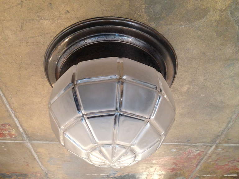 A large 1920s Austrian hammered copper flush ceiling fixture with a slight frosted geometric glass shade. The copper has a very nice darkened patina (burnt bronze color). Rewired.