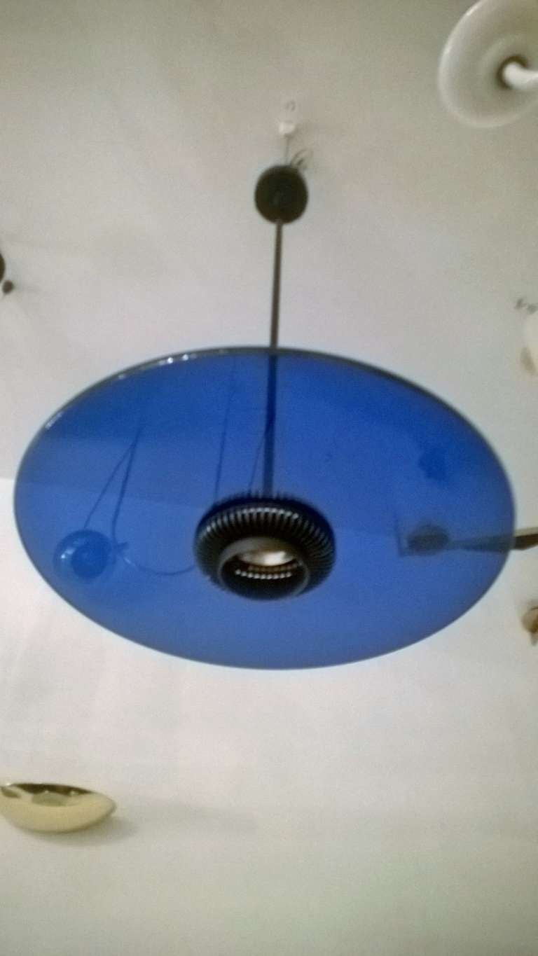 A Italian 1980s blue glass disc pendant on a brushed and black enamel fixture .called 