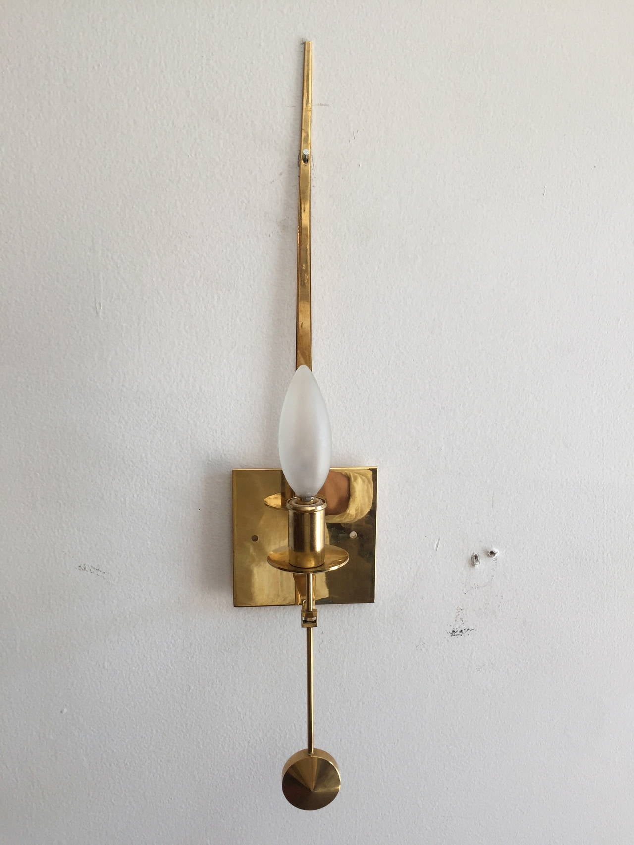 A great set of 1950s "Pendulum" Swedish brass sconces by Pierre Forssell for Skultuna. Rewired. Matching ball screws for the electrical box. No need for pictured nail once screwed into the box.