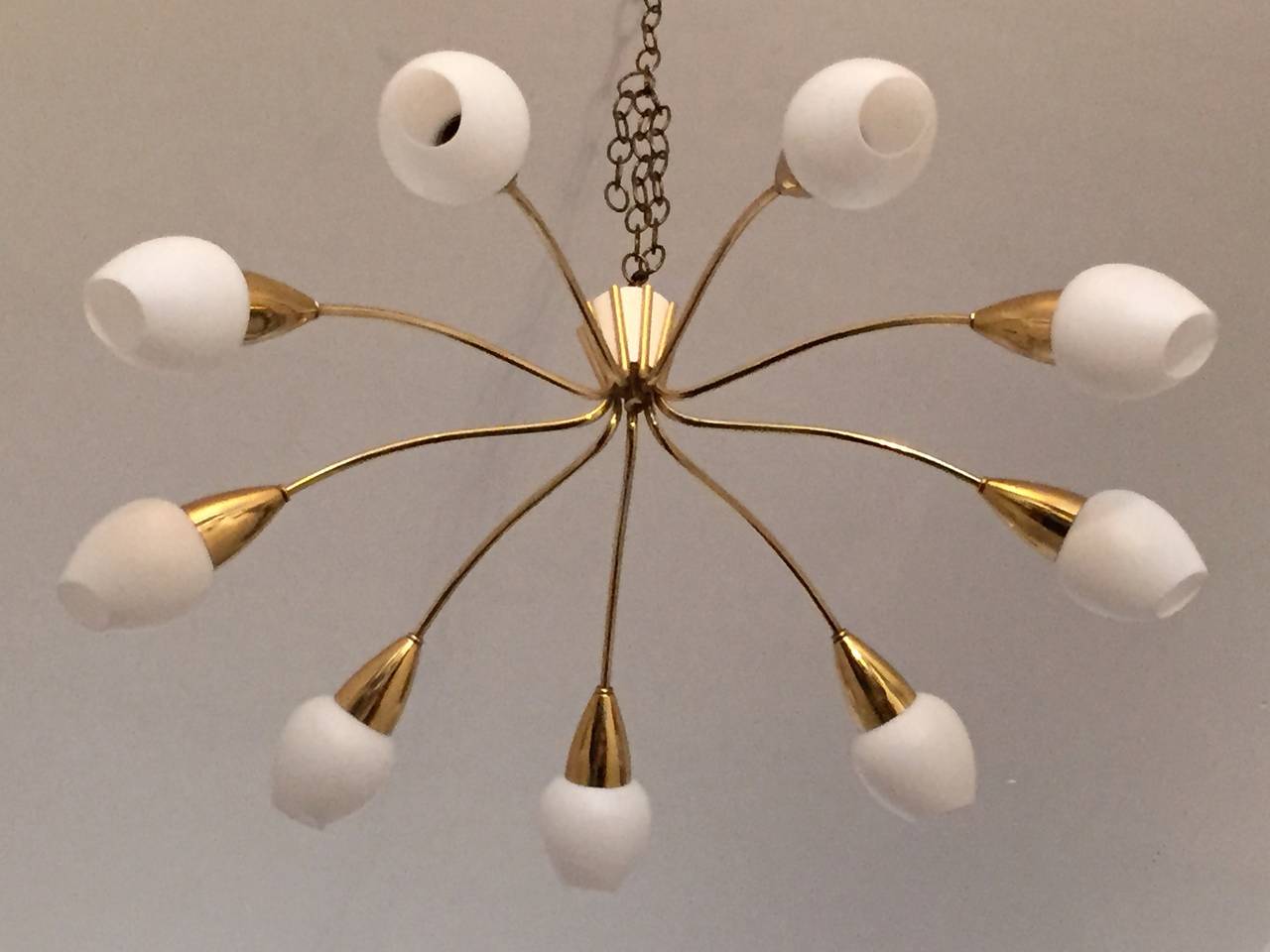 A wonderful pair of matching 1950s Italian, Mid-Century ceiling mounted flush chandeliers composed of polished brass fixtures with whited frosted tulip glass shades. Rewired. A pole can be provided to make them as hanging pendants if needed.