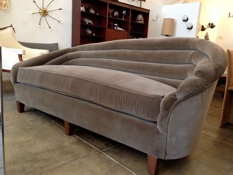 A great 1930's American Art Deco asymetrical swooping curved back sofa done in a mink color antique velvet.
Provenance: Estate of Richard Perry and Jane Fonda
                     Estate of Ronald Reagan and Jane Wyman