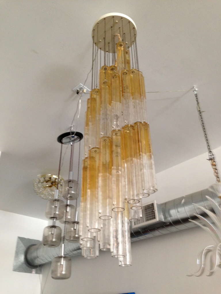 A wonderful cascading handblown amber and clear glass tube chandelier by the Murano firm, Venini. Signed.