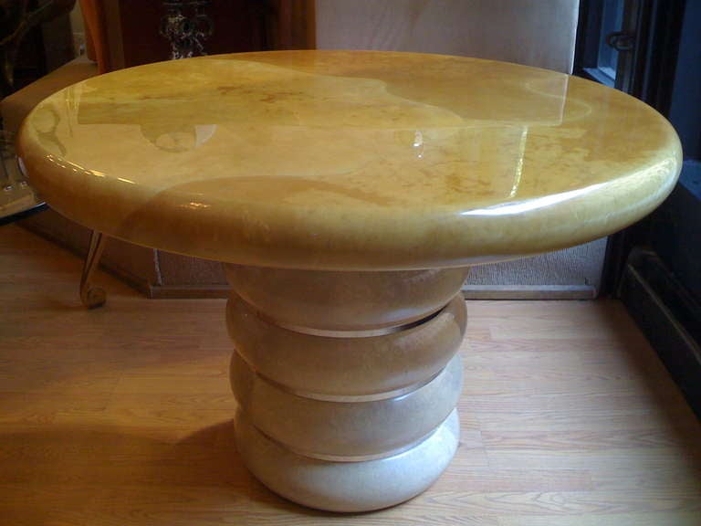 An original Ron Seff 1980s goatskin top and base with circular polished chrome bands. The table can be used for dining, a game table, or center table. The top is a golden cream color and the base is more a white cream color. Natural crackling on the