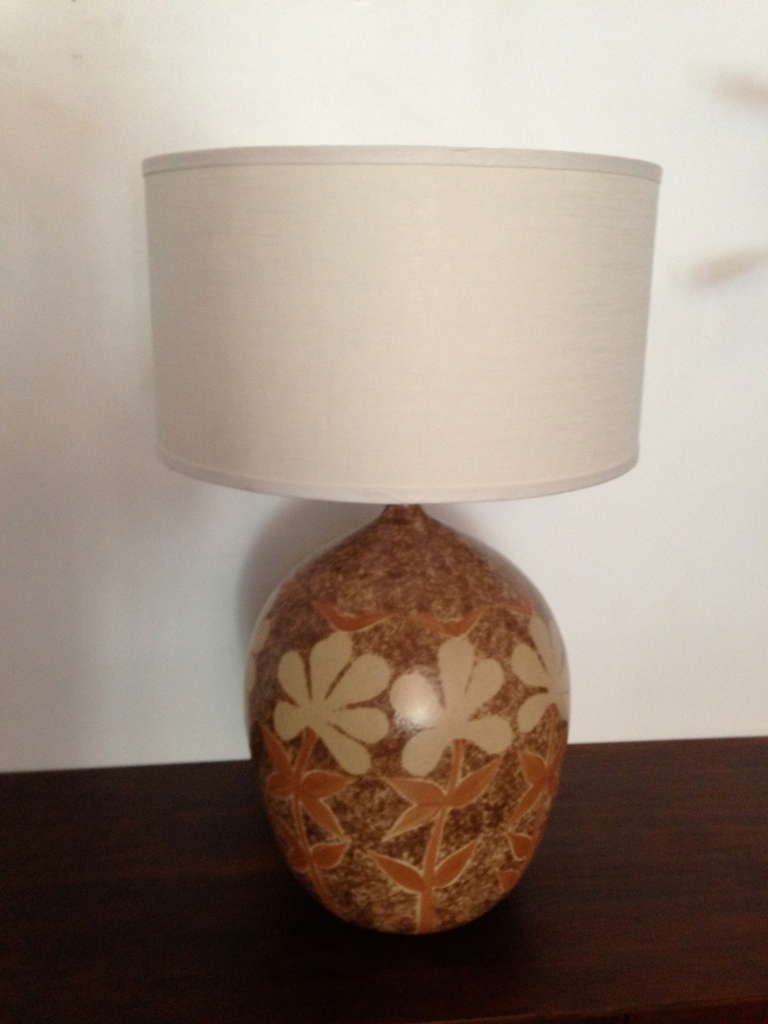 A pair of matte glazed earthenware 1970s American table lamps. Wood ball finials with linen shades.