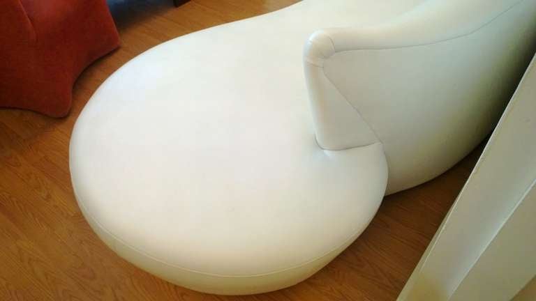 A white leather free-form shaped sofa with a polished chrome base by famed American designer, Vladimir Kagan.