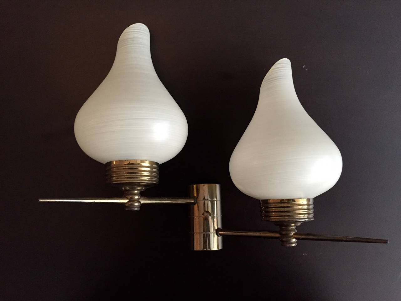 A nice pair of 1960s French wall lights composed of golden aged brass fixtures with tulip glass shades. Rewired.