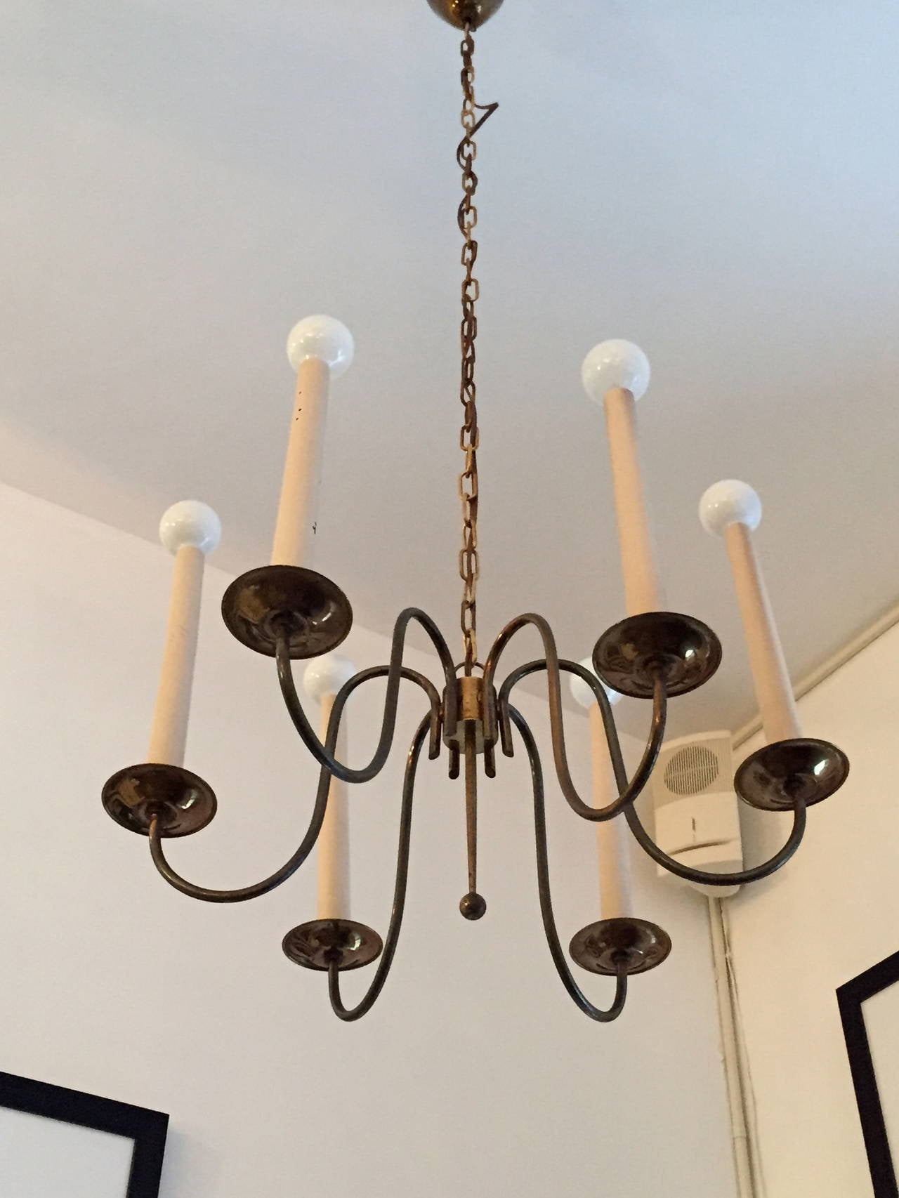 A wonderful 1950s French warm aged brass swooping six-arm chandelier. Rewired. 3 feet of chain and original canopy.