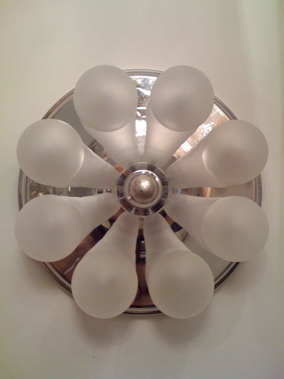 A high style 1970s wall or flush ceiling light by the German maker, Kinkeldey. A curved circular chrome fixture holding eight frosted glass ball shades.