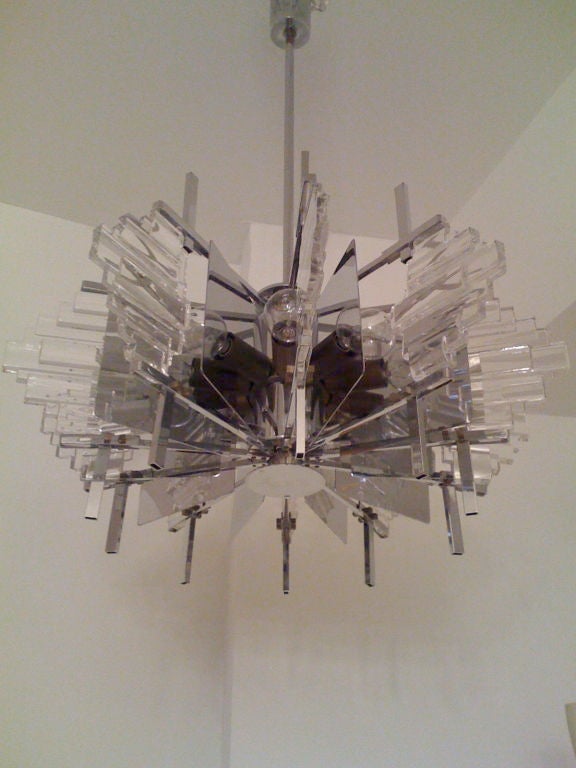 A rare 1960s, Italian modern chrome/brass and glass chandelier by Sciolari. Ten-light sources. The majority of the fixture is chrome with aged brass fittings.