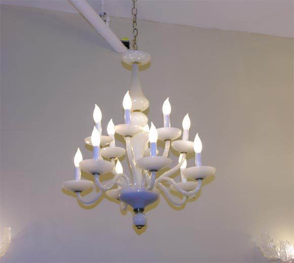 A great twelve-arm French white oplaline glass chandelier with brass accents.