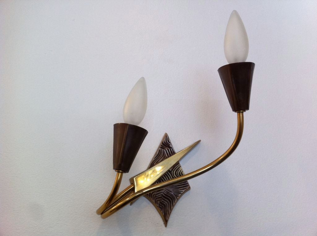 A pair of French decorative 1970s brass and bronze stylized wall lights. Two-light sources each.