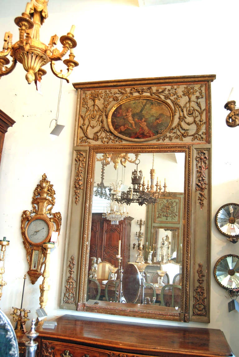 Painted, carved and gilded trumeau mirror with original oil on canvas painting.