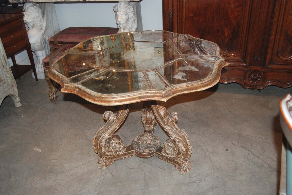 Carved,parcel-gilt, and mirrored table.