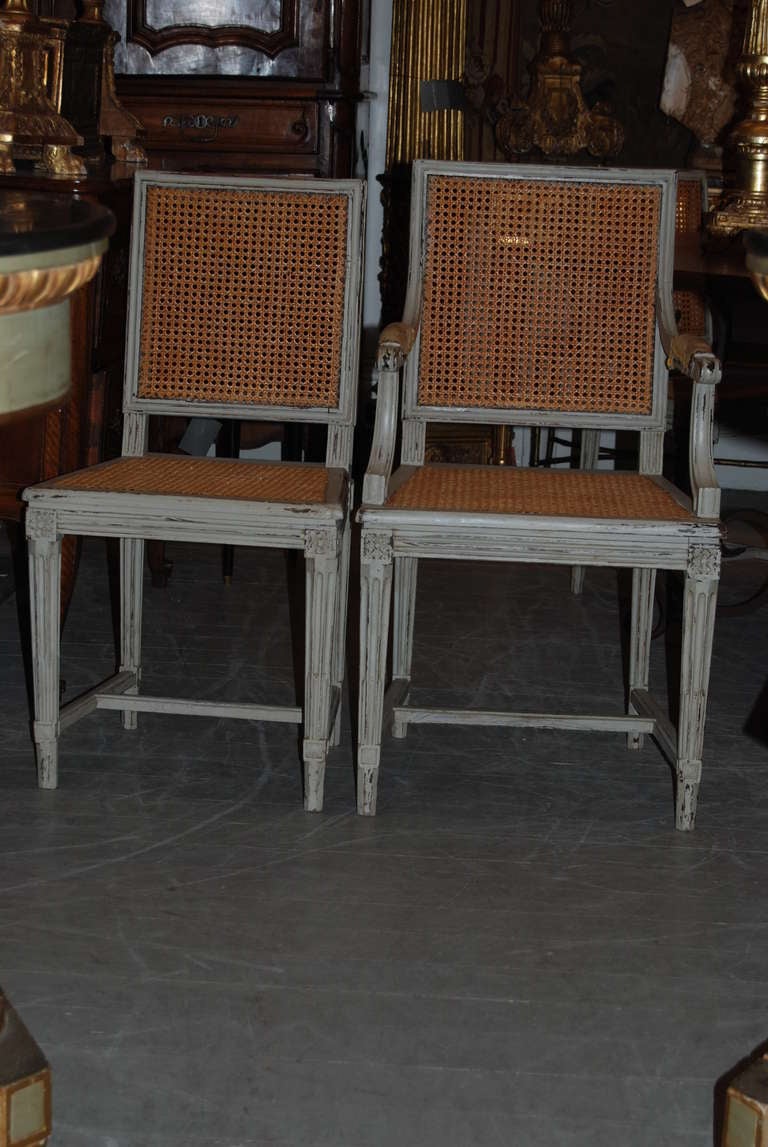 Strong and comfortable set of eight pained chairs-two arms and six sides.