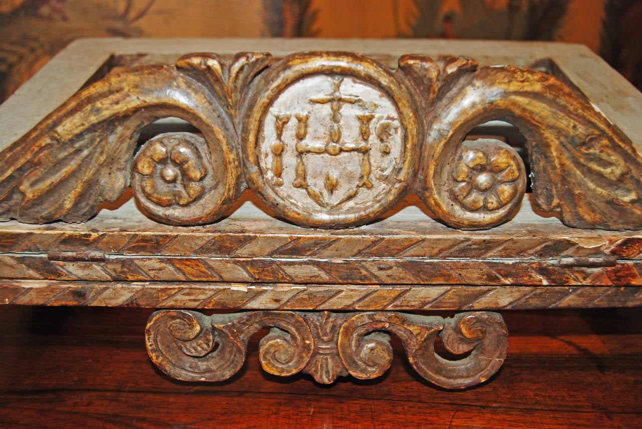 Carved bookstand with carved silver and giltwood accents.