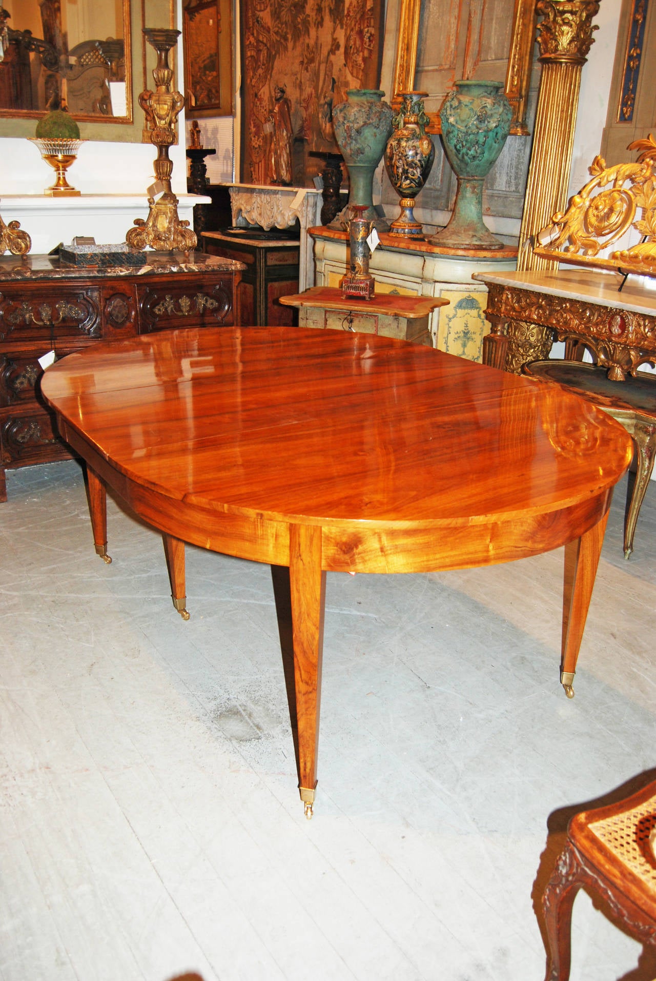 Beautiful pearwood extension table with two finished leaves and two unfinished leaves.