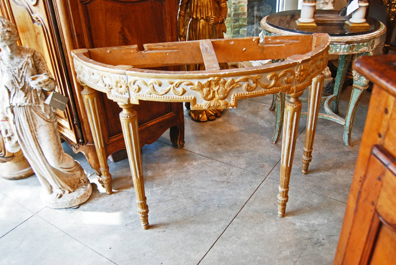 Painted, carved and gilded demilune console.