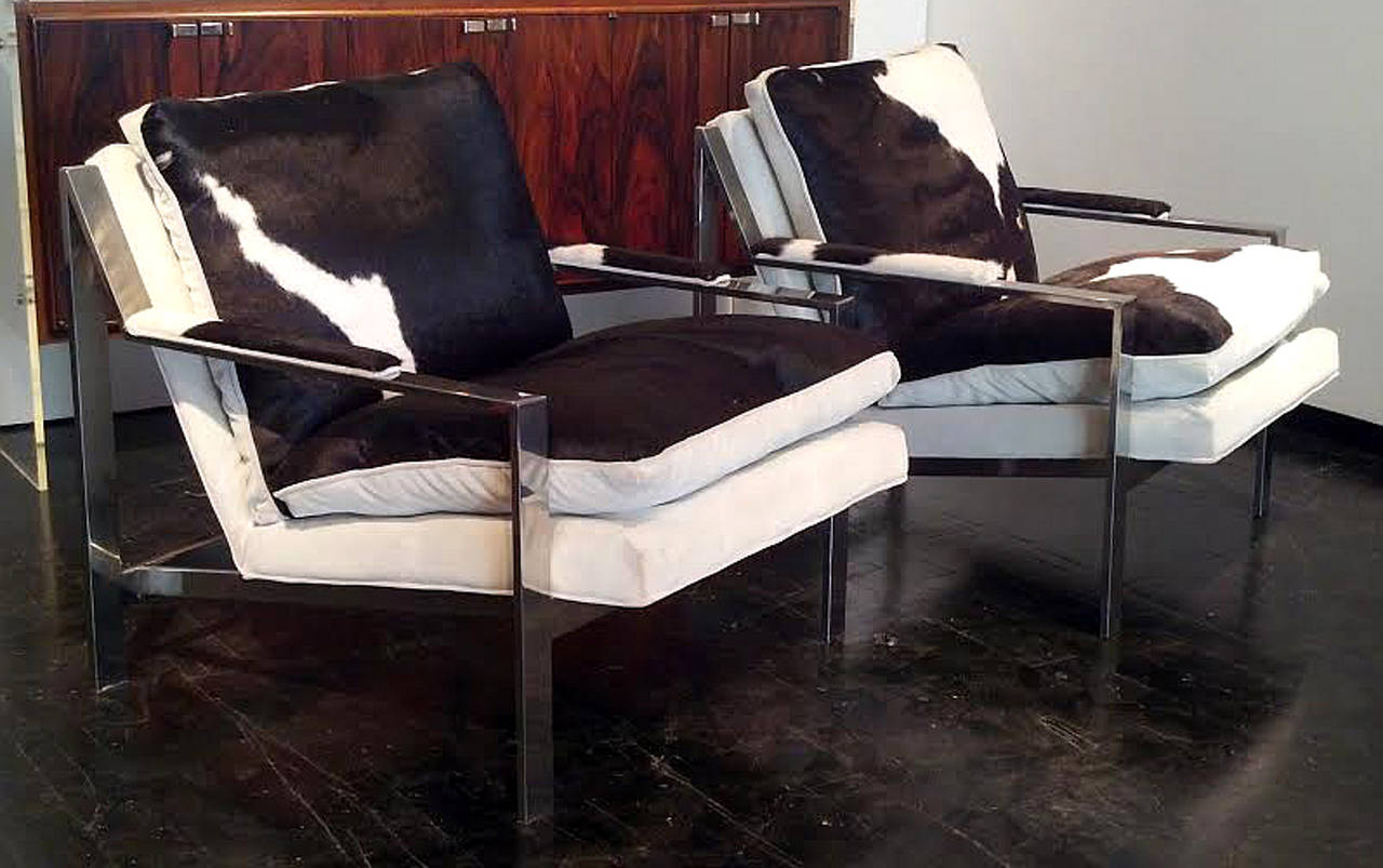 These Cy Mann chrome lounge chairs are in excellent vintage condition. Much in the style of Milo Baughman. The chrome, cowhide and ultra suede show little signs of wear. The down filled cushions are ultra soft. For being completely original these