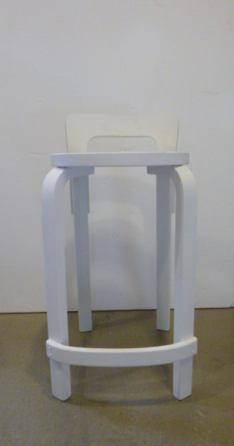 Pair of white bentwood counter-height bar stools by Alvar Aalto for Artek.  Finland, circa 1960.

Refinished in matte white.
