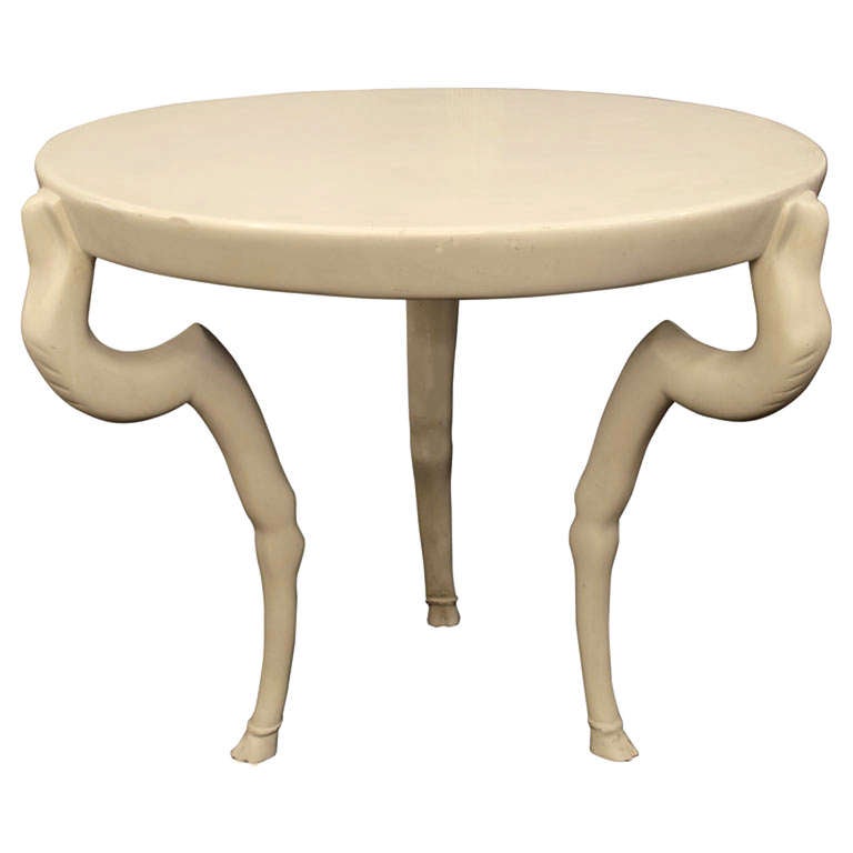 A Rare occasional table by Sirmos.   Circa  1970 this circular table with three animal form legs with hoofed feet is  finished in a white matte lacquer.  Great condition, an amazing form.