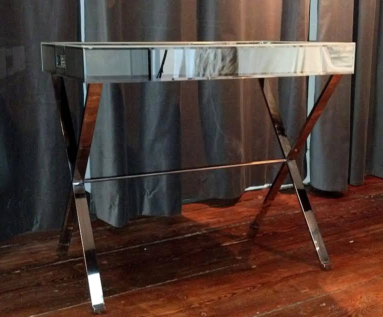 Very beautiful, very useful. These are the perfect occasional, cocktail, side or end tables.  Very sturdy chromed steel x-base frame with perfect beveled mirror tray top...Circa 1970's, very chic and very sturdy.