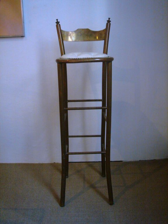 Set of four (4) polished brass bar stools with original tufted white leather seats and nailhead trim.  France, circa 1920.<br />
<br />
Height may be customized at no additional charge.  Current measurements as follows:<br />
40.5 inch total